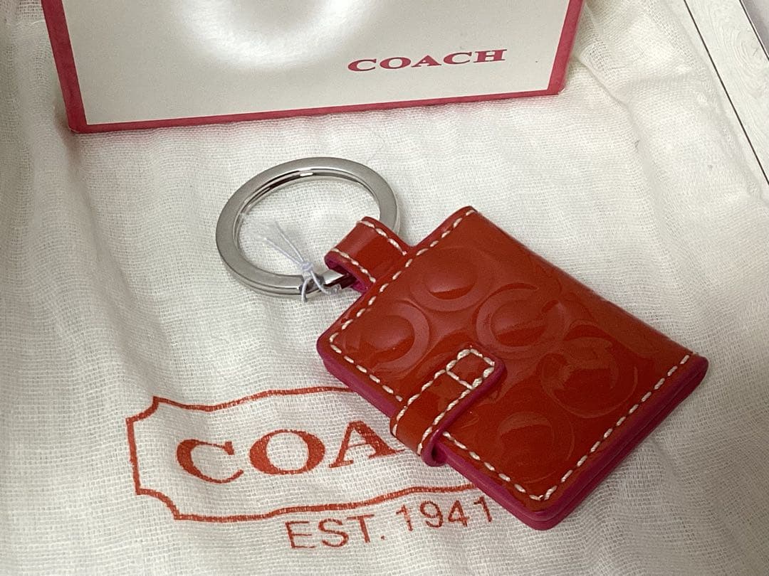 未使用タグ付きコーチCOACH オレンジ キーホルダー写真入れ手帳型本物